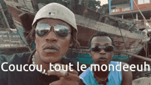 a man wearing sunglasses says coucou tout le mondeuul