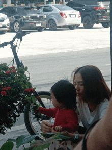 a woman and a little girl are looking at a phone