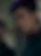 a man with purple hair has the words " you are " above his face