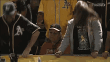 a woman wearing a shirt that says make energy drinks from canada