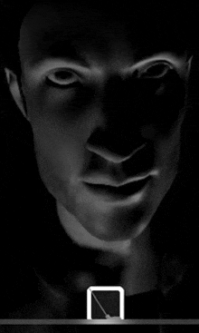 a black and white photo of a man 's face with a square in the middle