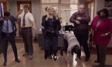 a group of people are dancing and one of them says " yay "