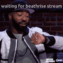 a man with a beard wearing a hat is waiting for beatrise stream on showtime