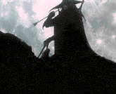 a silhouette of a man holding a sword and a spear