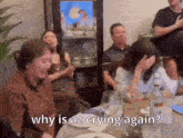 a group of people are sitting around a table and one woman is crying while another woman says why is az crying again