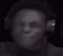 a blurry picture of a person smoking a cigarette