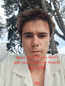 a man wearing a white shirt with the words wear black if you didn t kill your father on august 14th 2002