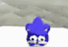 a blue cartoon character is standing in the snow with a mountain in the background .