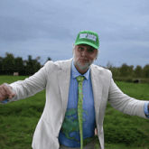 a man wearing a green hat which says make earth cool again