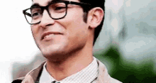 a close up of a man wearing glasses and a suit .