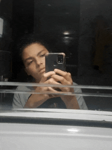 a young man is taking a selfie in a mirror