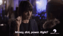 a woman is talking to another woman and saying money , dick , power . right ?
