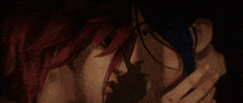 a close up of two women kissing with red hair and blue hair