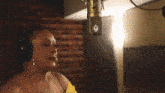 a woman is singing into a microphone in a recording studio .