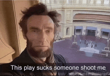 a man with a beard is standing in front of a building with the caption this play sucks someone shoot me