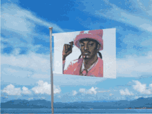 a picture of snoop dogg in a pink hat is flying in the wind