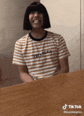 a person wearing a striped shirt that says explore