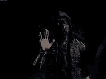 a person wearing a mask and a jacket with spikes on it