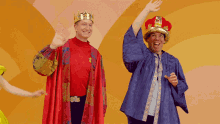 a man wearing a crown is standing next to another man