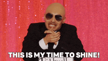 a man wearing sunglasses and a suit says this is my time to shine