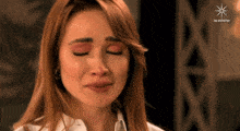 a close up of a woman 's face with the words las estrellas on the bottom right