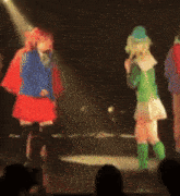 a blurry picture of a group of people dancing on stage