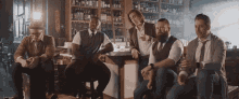 a group of men are sitting around a bar in a bar