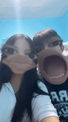 a man and a woman making funny faces with their mouths wide open