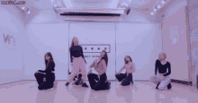 a group of girls are dancing in front of a wall that says chamber on it
