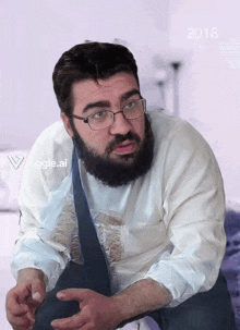 a man with a beard wearing glasses and a white shirt with the year 2018