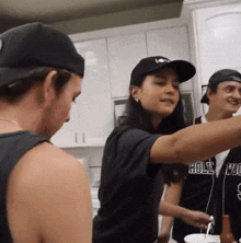 a woman wearing a black hat and a black shirt that says holly