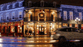 a car is driving past a building with a wreath on the front