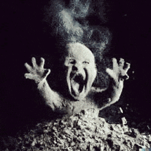 a black and white photo of a ghost with its mouth open coming out of a pile of ashes .