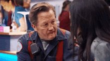 a man with a walkie talkie talking to a woman