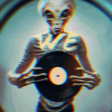 an alien is holding a record in his hands with the word love on it