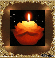 a picture of a lit candle in a gold frame with the word blingee on the bottom