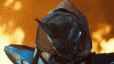 a close up of a person wearing a helmet with horns and a hood