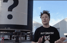 a man in a black shirt that says buy $ maybe