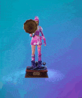 a statue of a woman holding a phonograph with a music note coming out of it