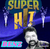 a man with a beard is standing in front of a super hit sign