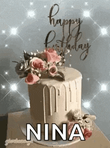 a birthday cake with flowers on top of it and the words `` happy birthday nina '' .