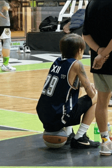 a man wearing a basketball jersey with the number 29 on it