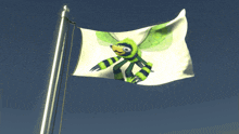 a flag with a dragonfly on it is flying in the wind