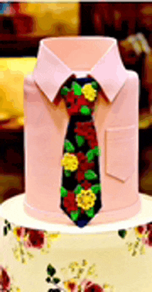 a cake with a pink shirt and tie on it .