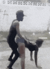 a man is riding a woman on his back while she does push ups .