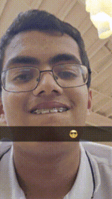 a man wearing glasses and braces is smiling with a smiley face on his face