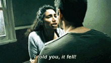 a man and a woman are looking at each other and the woman says i told you it fell