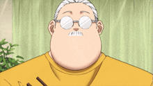 a man with glasses and a yellow shirt is holding chopsticks