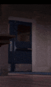 a woman in a blue sweater is walking through a doorway