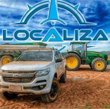 a chevrolet truck and a john deere tractor are parked in the dirt